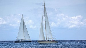 Two sailboats on a calm sea.